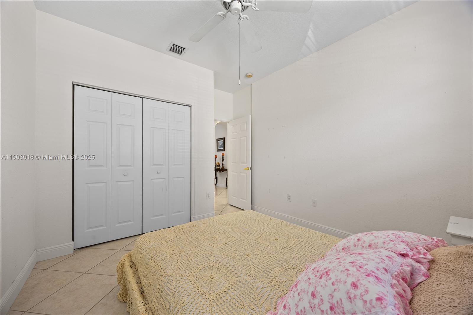 2658 Southwest 189th Avenue Miramar, FL 33029 - Photo 35 of 67 a bedroom with a bed and a chandelier fan