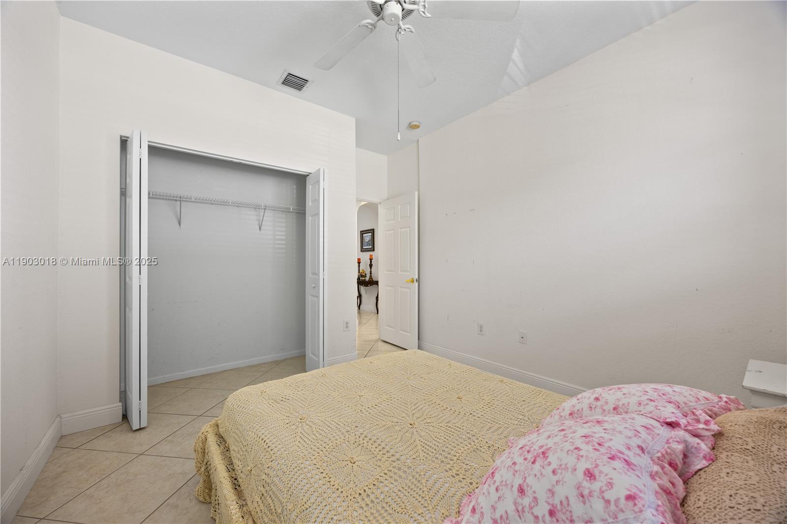 2658 Southwest 189th Avenue Miramar, FL 33029 - Photo 36 of 67 a bedroom with a bed and a chandelier fan