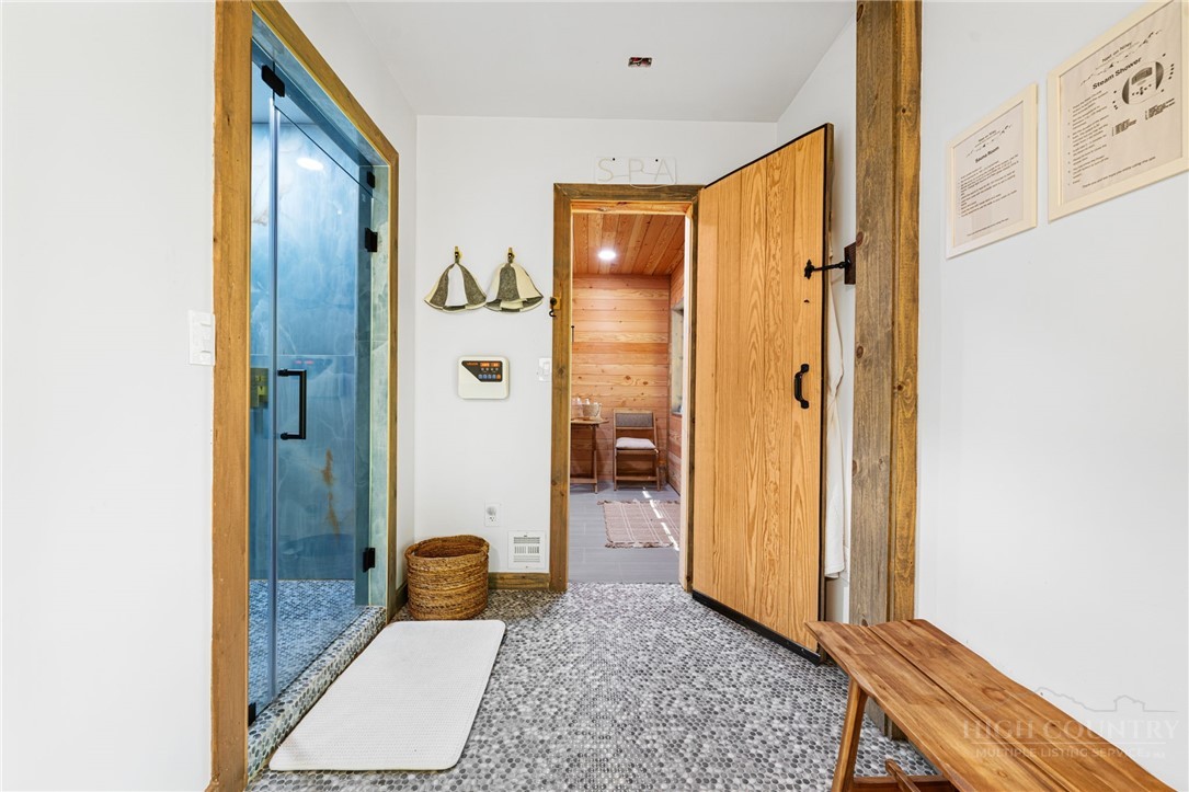1385 Niley Cook Road Blowing Rock, NC 28605 - Photo 28 of 40 a bathroom with a granite countertop shower and a mirror
