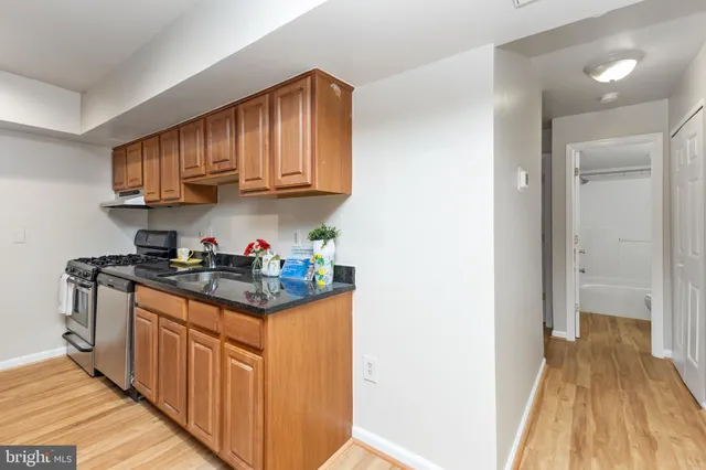 a kitchen with stainless steel appliances granite countertop a stove and a sink