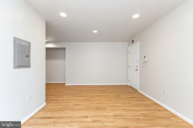 a view of an empty room with wooden floor