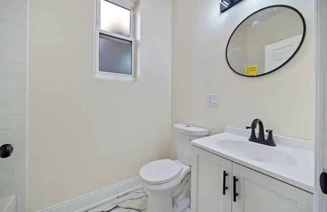 a bathroom with a toilet and a sink