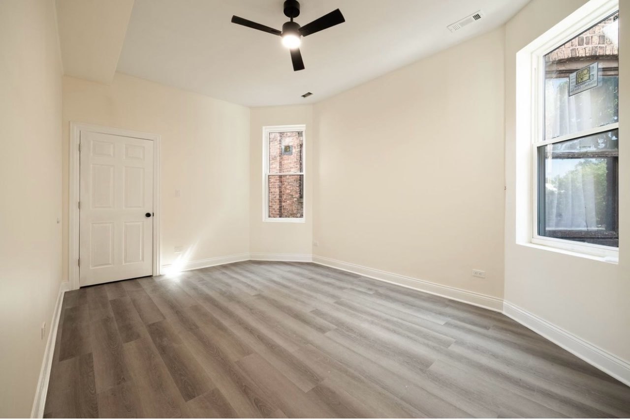 5617 South Laflin Street, Unit 2 Chicago, IL 60636 - Photo 7 of 9 wooden floor in an empty room with a window