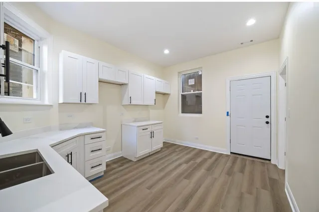 a room with cabinets and wooden floor