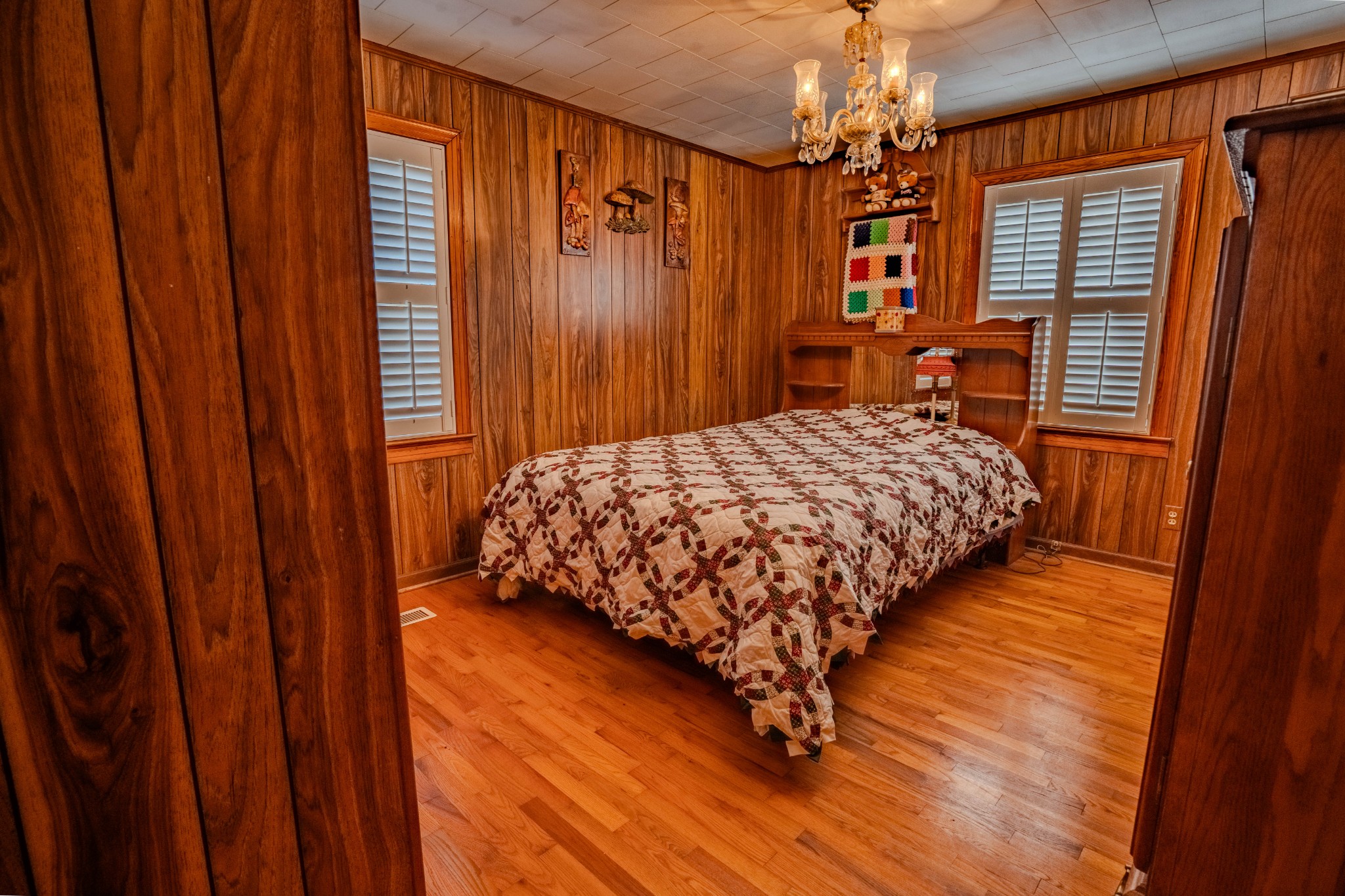25 Peters Lane Loretto, TN 38469 - Photo 21 of 44 a bedroom with a bed and a chandelier