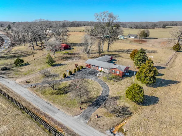 a tall yellow building in the middle of a yard