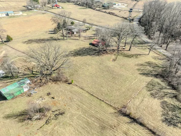 a view of a yard with wooden fence