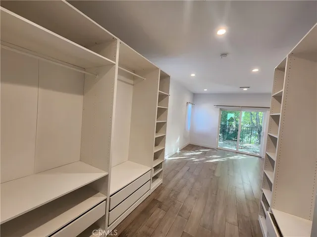 a view of hallway with wooden floor and window