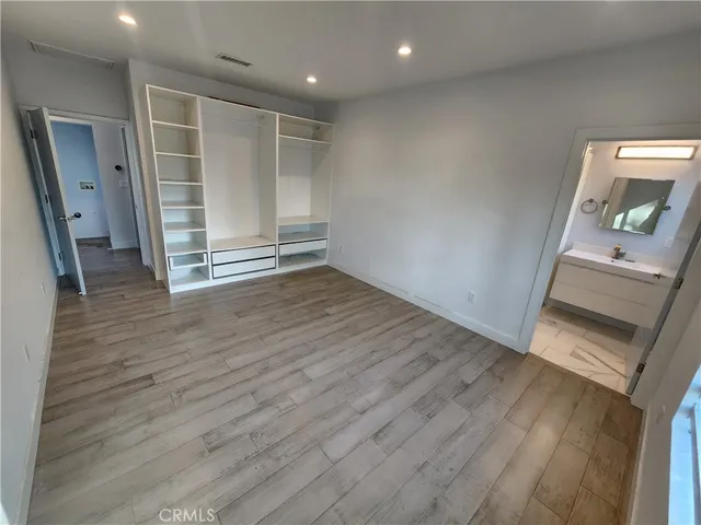 wooden floor in an empty room with a mirror