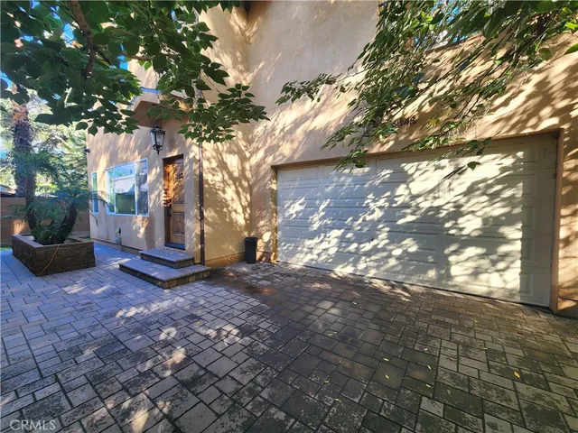 a view of a tree with yard in front of it