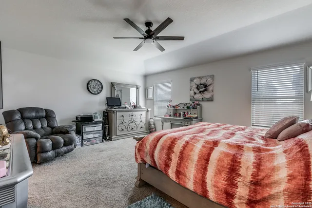 a bedroom with a bed a couch and dresser