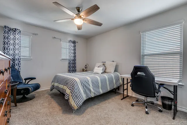 a bedroom with a bed chair and a window