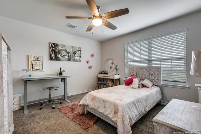 a bedroom with a bed and a desk