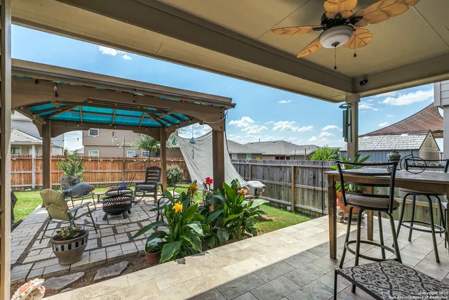 a view of a chairs and table in the patio