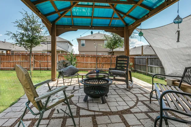 a view of a chair and tables in the patio