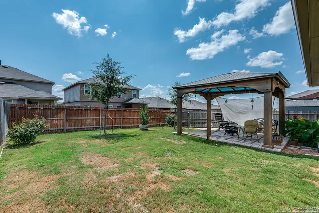 a view of a house with backyard and porch