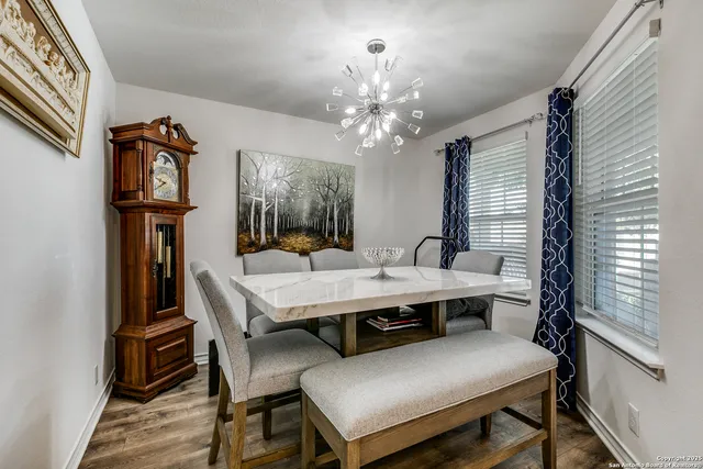 a view of a dining room with furniture and a chandelier