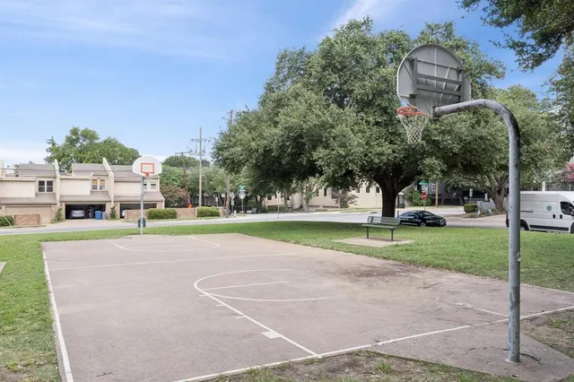 a view of a house with a big yard and large trees