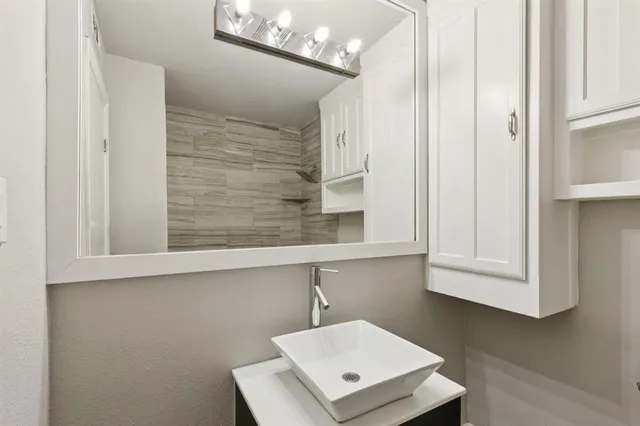 a living room with a wooden floor and white wall