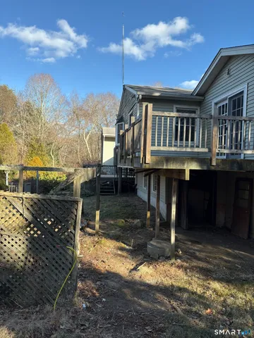 a view of a house with a wooden deck