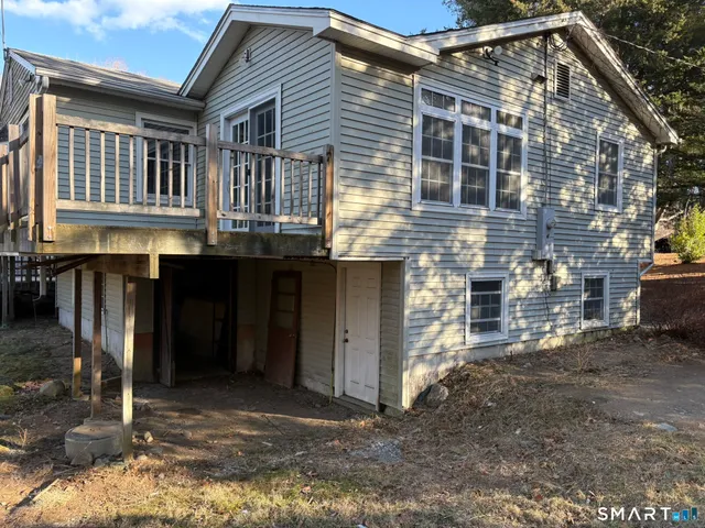 a backyard of a house with barbeque oven and outdoor seating