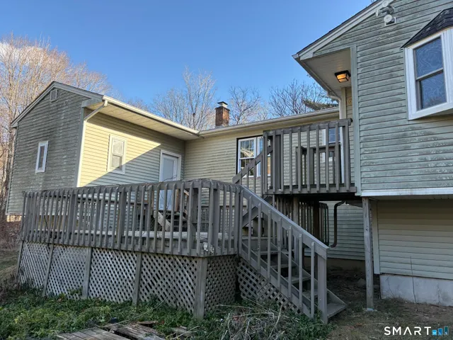 a view of a wooden house with a small deck and wooden floor
