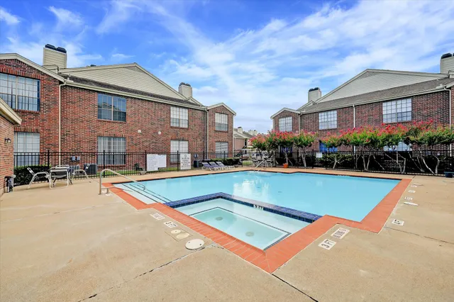 a view of a building with a swimming pool and sitting area