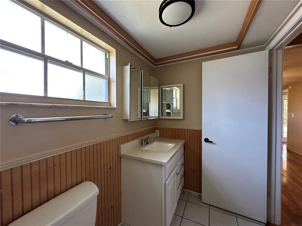 8809 Avondale Lane Hudson, FL 34667 - Photo 11 of 46 a bathroom with a granite countertop sink and a mirror