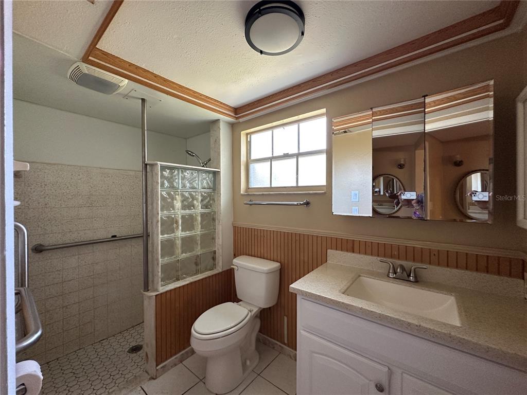 8809 Avondale Lane Hudson, FL 34667 - Photo 12 of 46 a bathroom with a sink a toilet and a shower