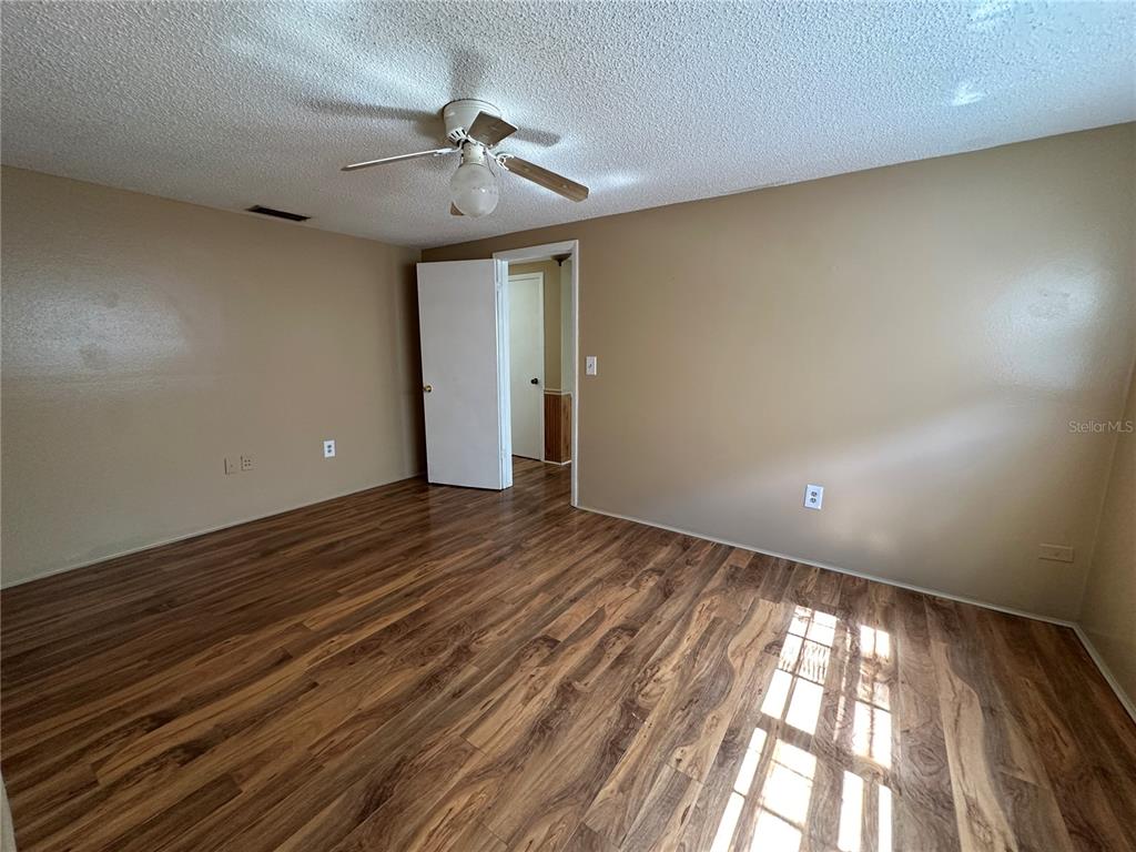 8809 Avondale Lane Hudson, FL 34667 - Photo 18 of 46 a view of room window and wooden floor