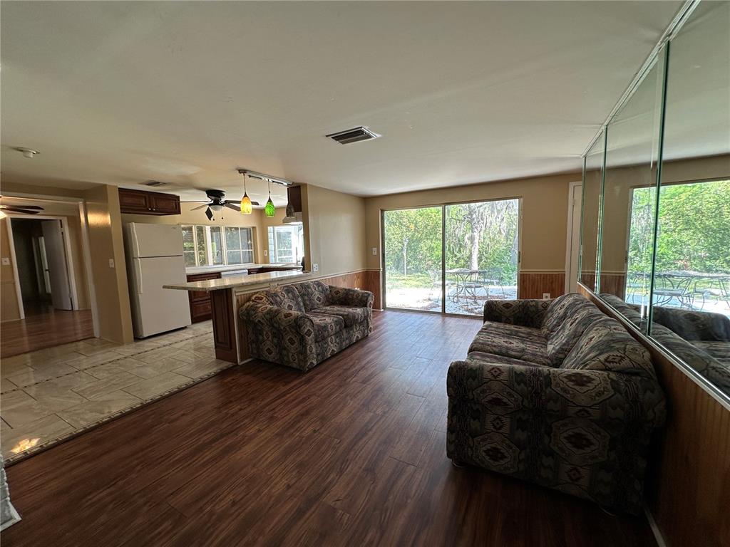 8809 Avondale Lane Hudson, FL 34667 - Photo 22 of 46 a living room with furniture and a large window