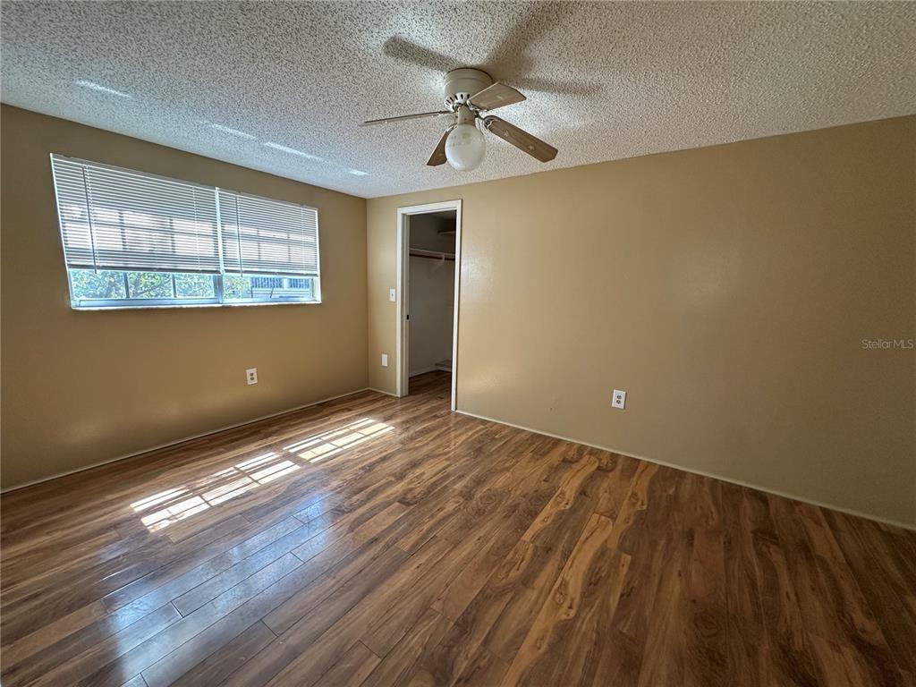 8809 Avondale Lane Hudson, FL 34667 - Photo 23 of 46 a view of empty room with wooden floor and fan