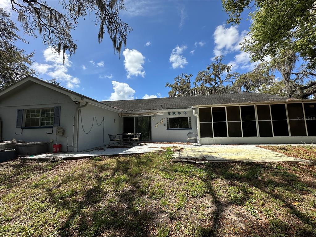 8809 Avondale Lane Hudson, FL 34667 - Photo 28 of 46 a view of a house with a yard and garage