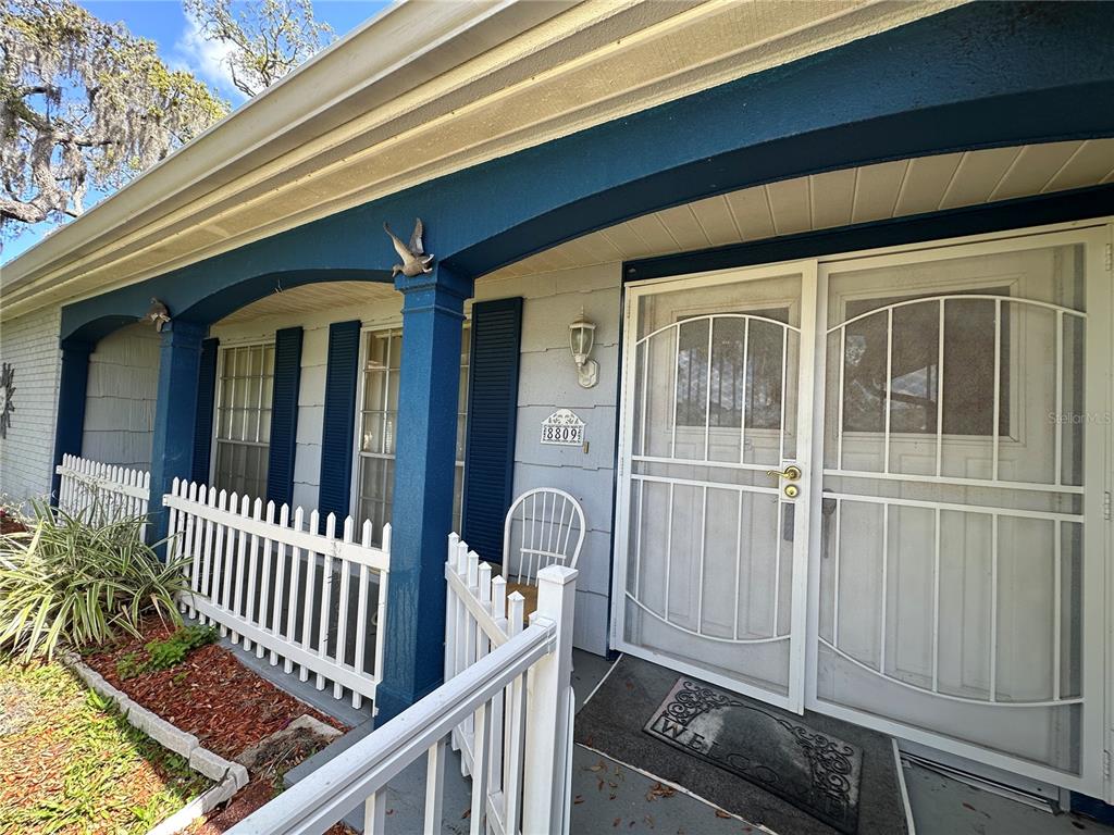 8809 Avondale Lane Hudson, FL 34667 - Photo 3 of 46 a front view of a house with a porch