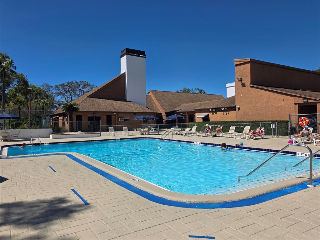 8809 Avondale Lane Hudson, FL 34667 - Photo 37 of 46 a view of a swimming pool with lounge chair
