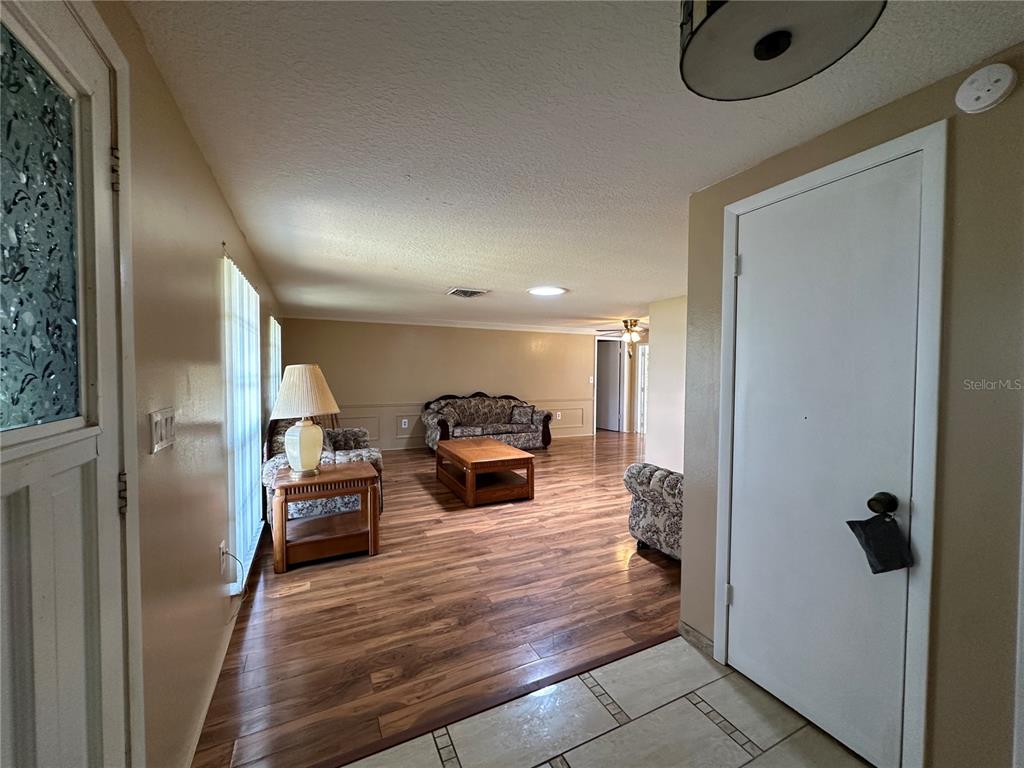 8809 Avondale Lane Hudson, FL 34667 - Photo 4 of 46 a living room with furniture and a wooden floor