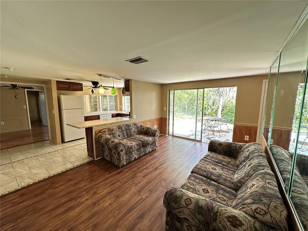 8809 Avondale Lane Hudson, FL 34667 - Photo 5 of 46 a living room with furniture and a large window