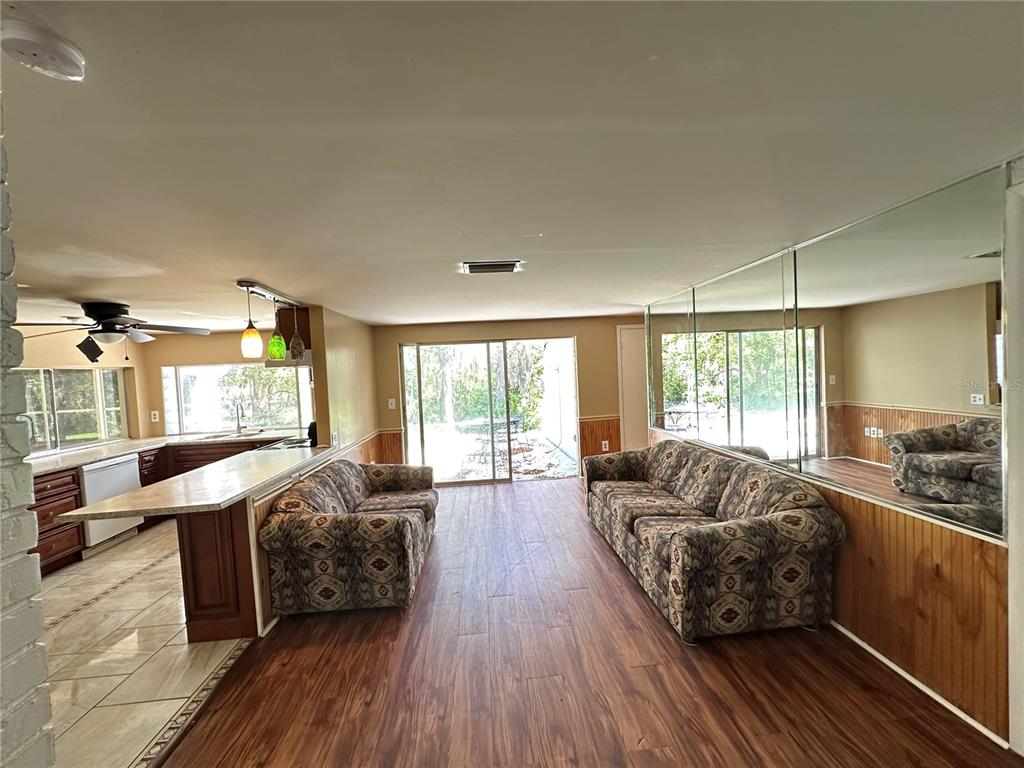 8809 Avondale Lane Hudson, FL 34667 - Photo 6 of 46 a living room with furniture and a large window
