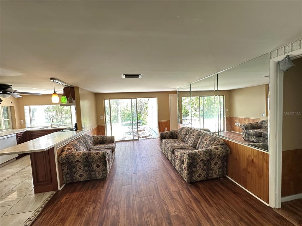 8809 Avondale Lane Hudson, FL 34667 - Photo 7 of 46 a living room with furniture and a large window