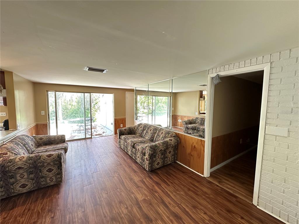 8809 Avondale Lane Hudson, FL 34667 - Photo 8 of 46 a living room with furniture and a large window
