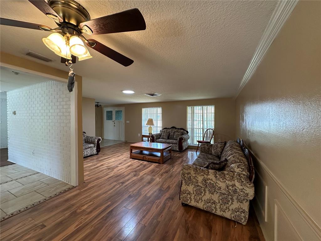 8809 Avondale Lane Hudson, FL 34667 - Photo 10 of 46 a living room with furniture and a wooden floor