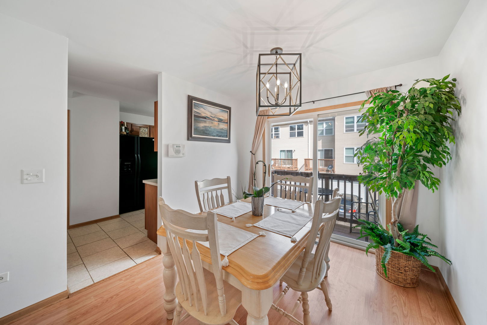 34325 North Barberry Road Round Lake, IL 60073 - Photo 8 of 21 a dining room with furniture potted plants and wooden floor
