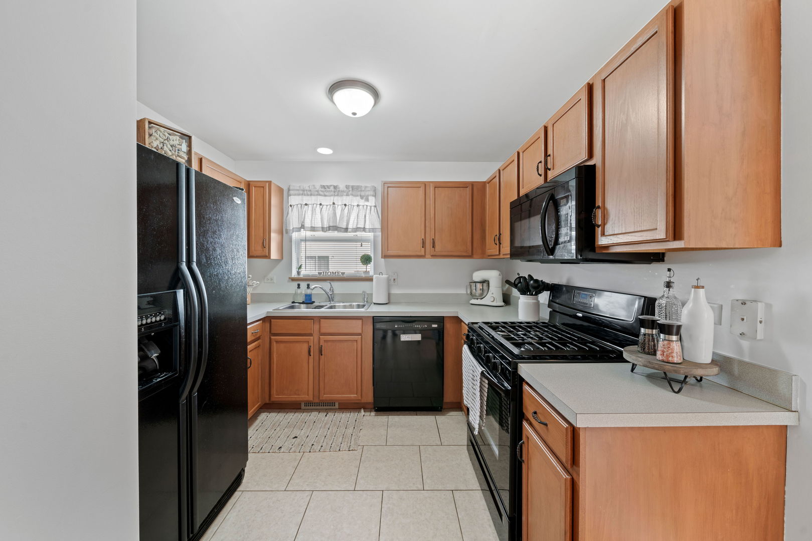 34325 North Barberry Road Round Lake, IL 60073 - Photo 9 of 21 a kitchen with stainless steel appliances granite countertop a sink stove and refrigerator