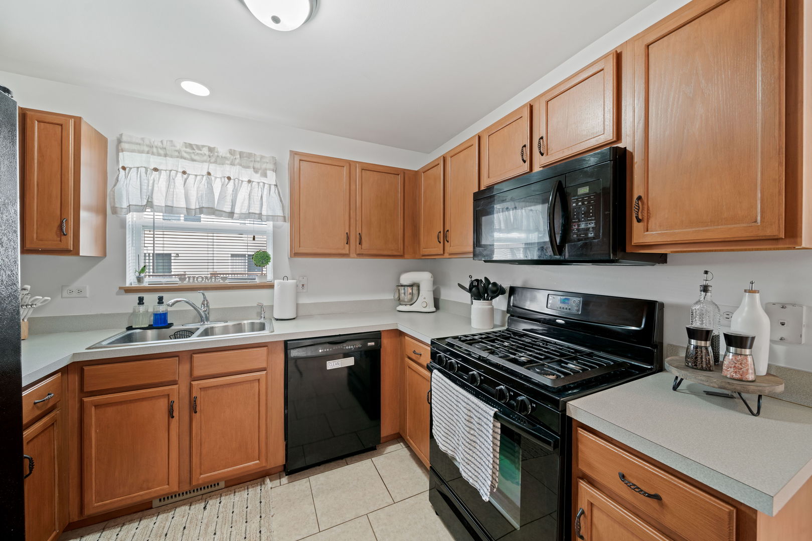 34325 North Barberry Road Round Lake, IL 60073 - Photo 10 of 21 a kitchen with a sink stove top oven and cabinets