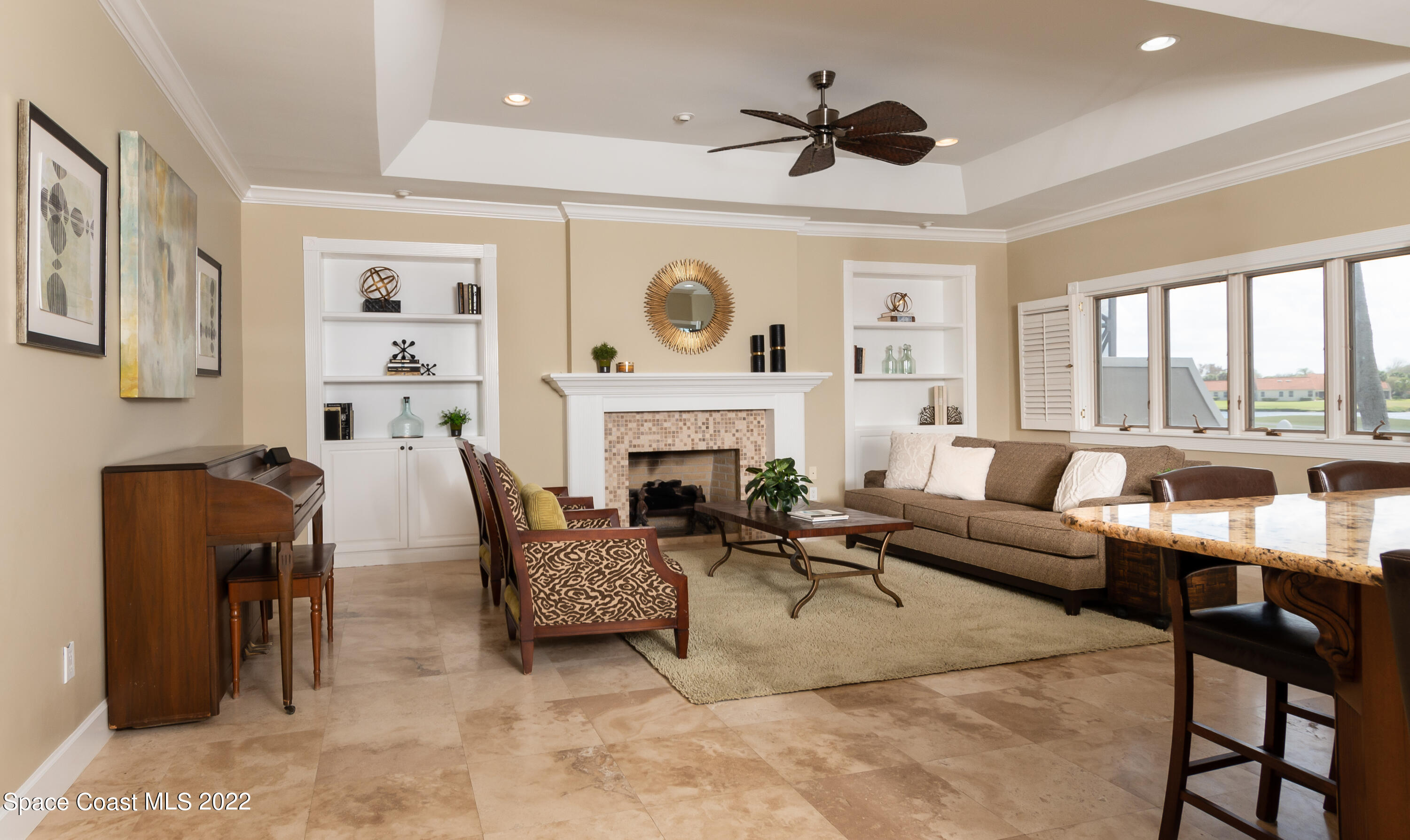 870 Kerry Downs Circle Melbourne, FL 32940 - Photo 13 of 41 a living room with furniture fireplace and a large window