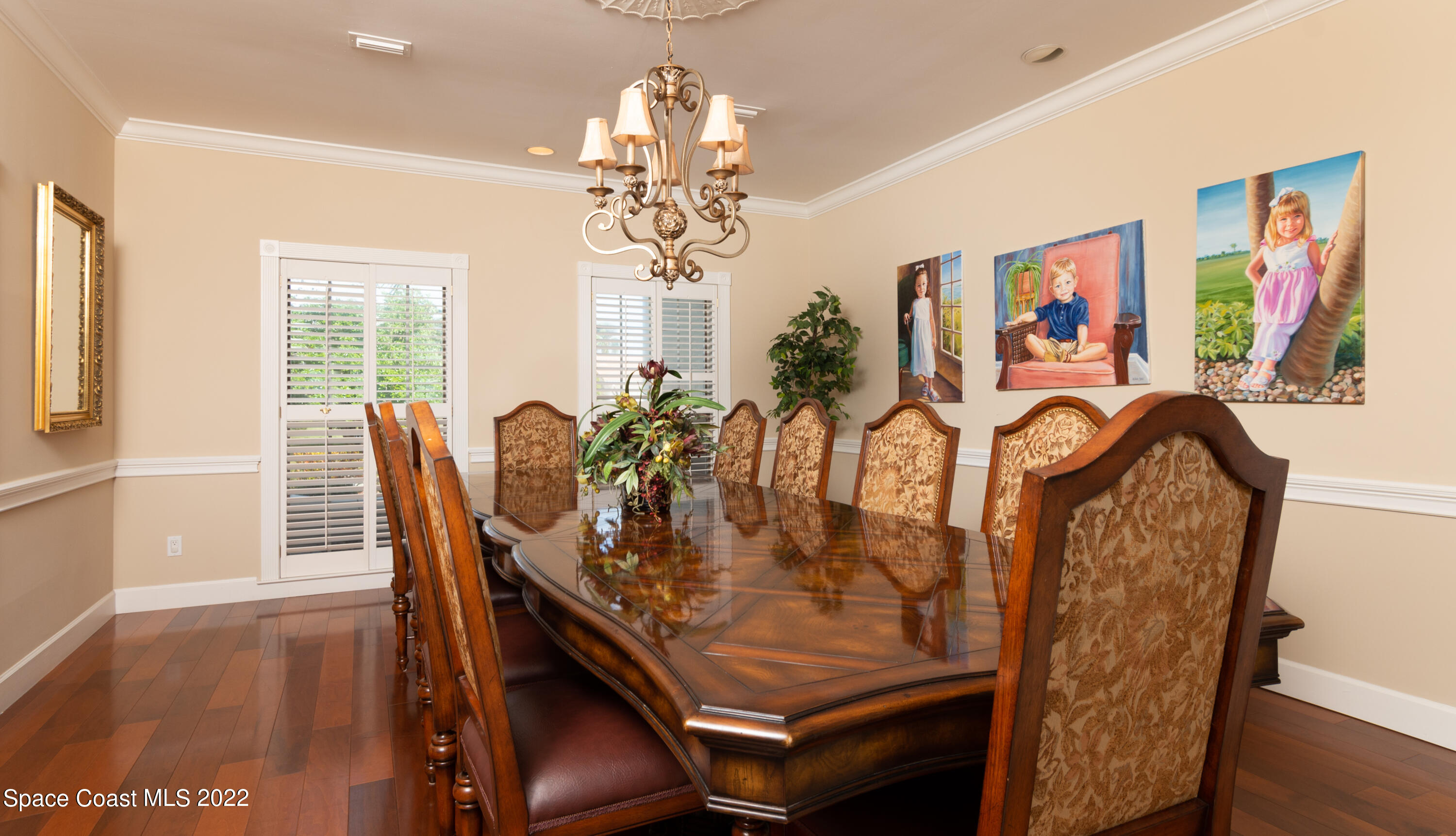870 Kerry Downs Circle Melbourne, FL 32940 - Photo 16 of 41 a view of a dining room with furniture wooden floor and chandelier