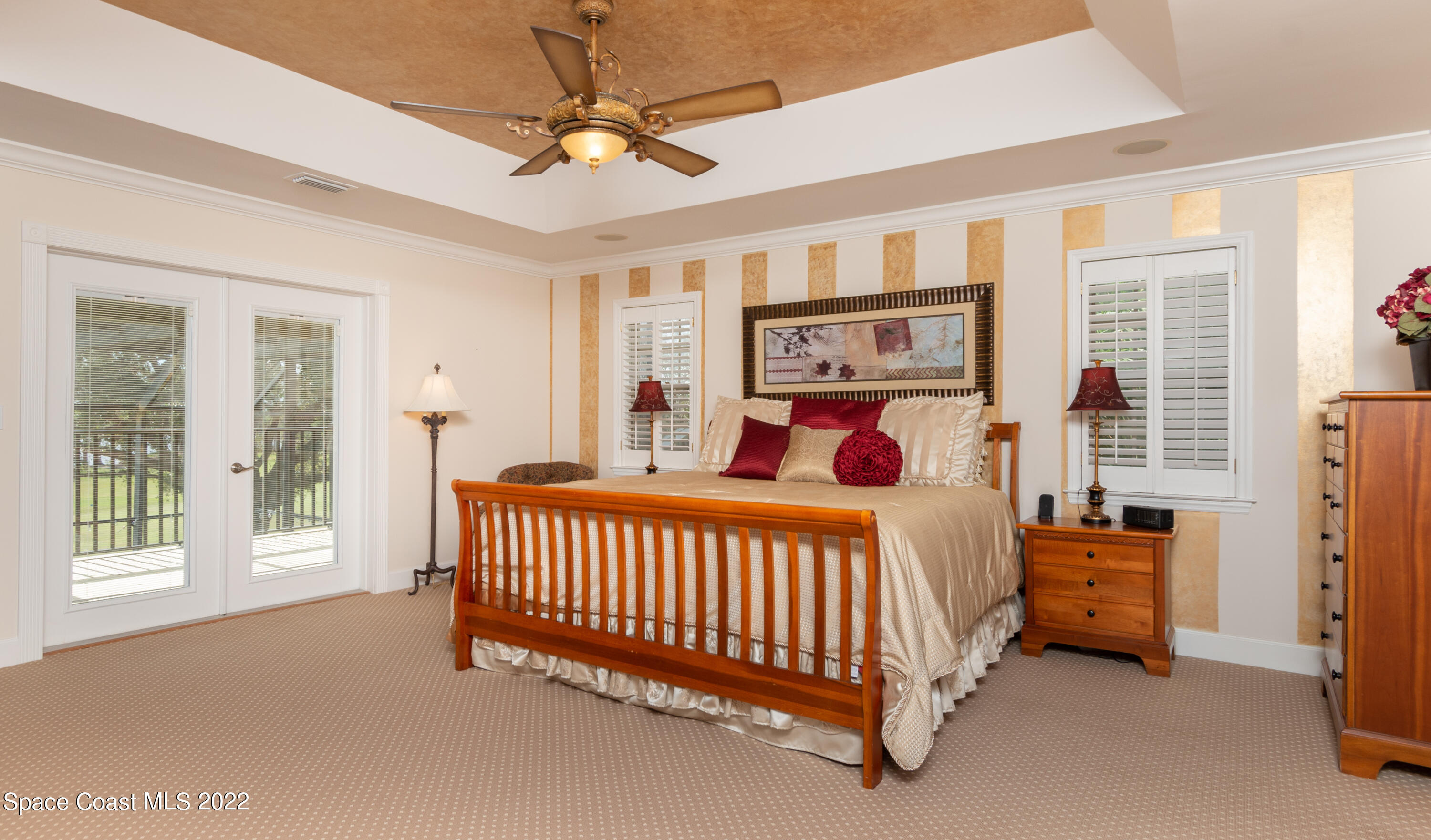 870 Kerry Downs Circle Melbourne, FL 32940 - Photo 19 of 41 a bed sitting in a bedroom next to a window