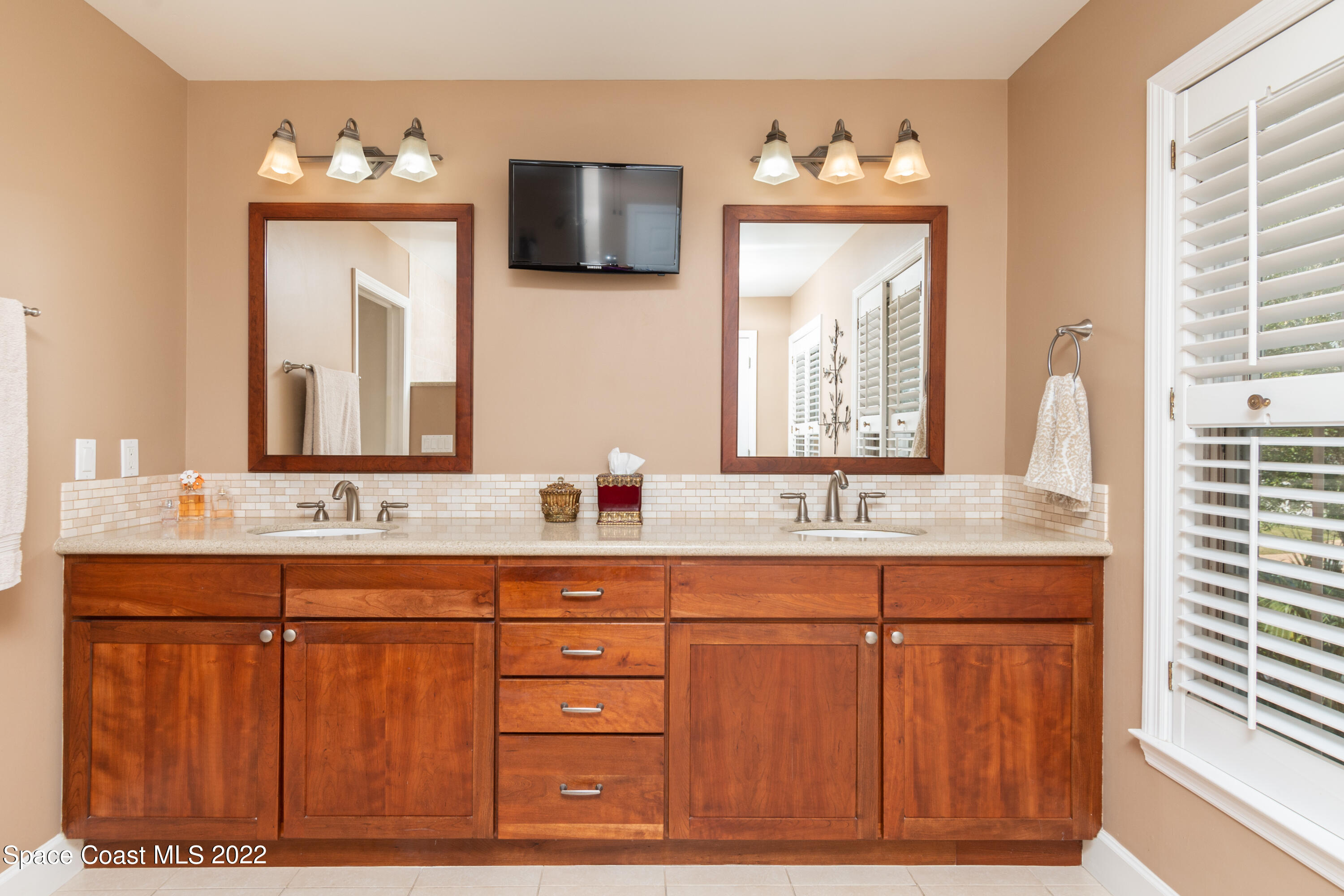 870 Kerry Downs Circle Melbourne, FL 32940 - Photo 20 of 41 a bathroom with a double vanity sink and a mirror