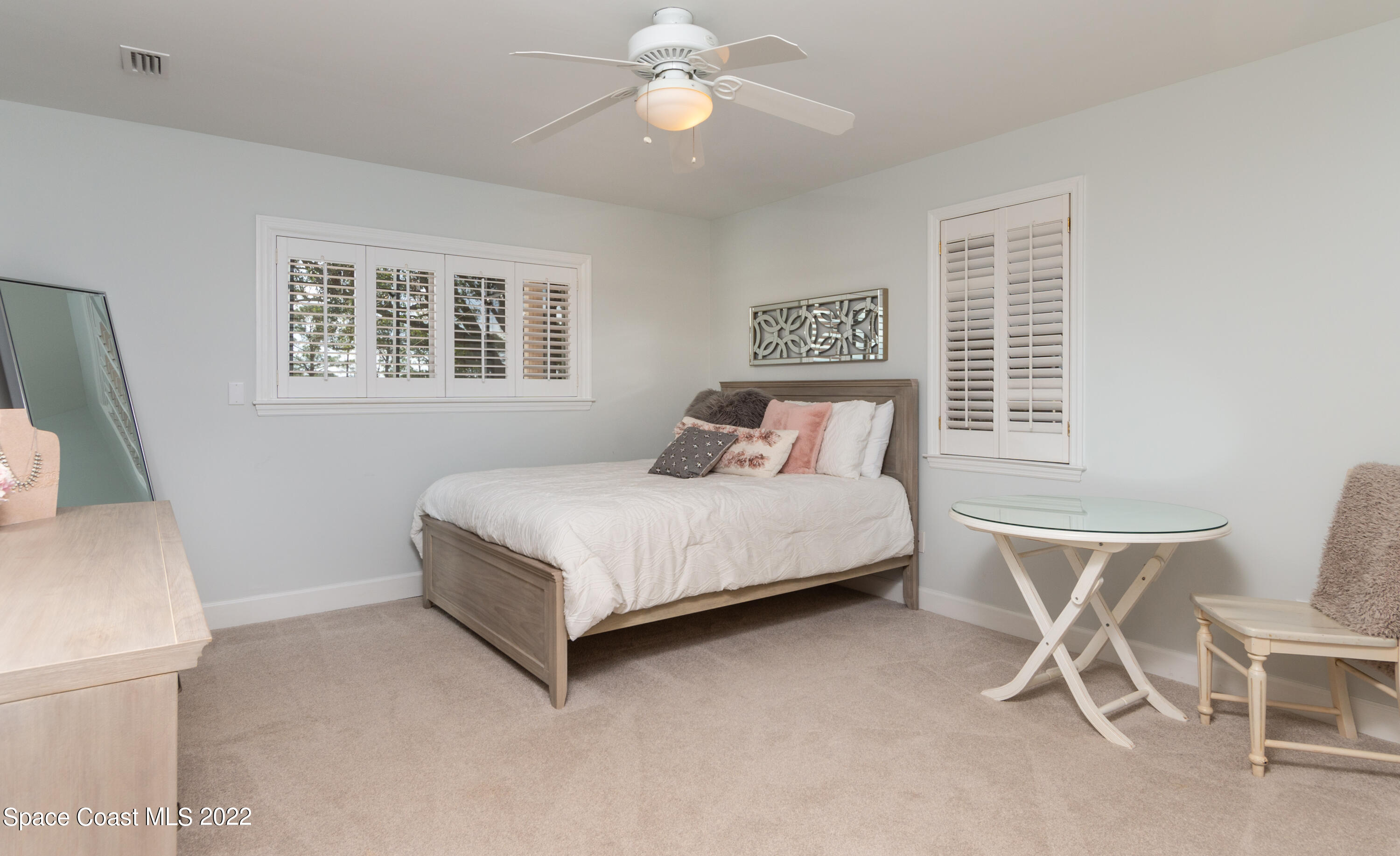 870 Kerry Downs Circle Melbourne, FL 32940 - Photo 23 of 41 a bedroom with a large bed and a window
