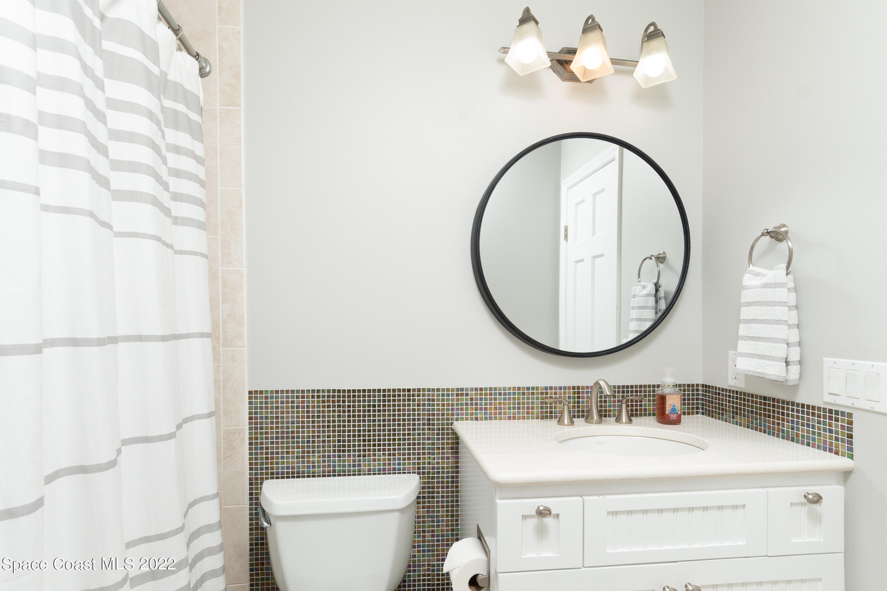 870 Kerry Downs Circle Melbourne, FL 32940 - Photo 27 of 41 a bathroom with a sink a toilet and a mirror